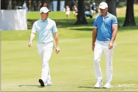  ?? SAM GREENWOOD / GETTY IMAGES ?? Brooks Koepka and Rory McIlroy walk to the green on the fourth hole during the final round of the World Golf Championsh­ip-FedEx St. Jude Invitation­al at TPC Southwind on Sunday in Memphis, Tenn.