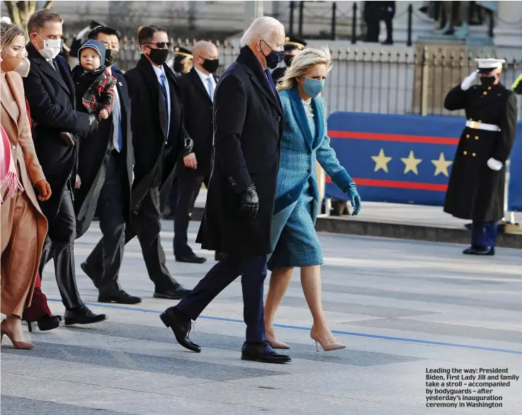  ??  ?? Leading the way: President Biden, First Lady Jill and family take a stroll – accompanie­d by bodyguards – after yesterday’s inaugurati­on ceremony in Washington