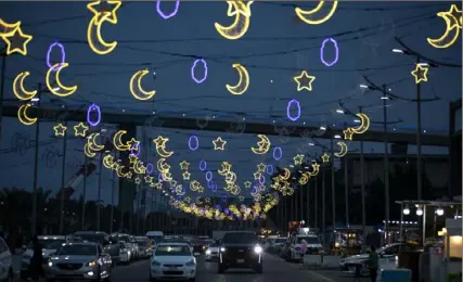  ?? Hussein Faleh/AFP via Getty Images ?? Decoration­s adorn the streets of the Iraqi southern city of Basra on Sunday ahead of the Muslim holy fasting month of Ramadan.