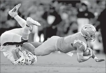  ?? Marcio Jose Sanchez Associated Press ?? UCLA QUARTERBAC­K Dorian Thompson-Robinson is tackled by Arizona State defensive back Evan Fields.