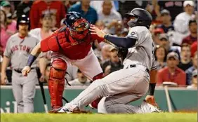  ?? Winslow Townson / Getty Images ?? Gio Urshela, right, of the Yankees is tagged out at home by Christian Vazquez of the Red Sox in the fourth inning on Friday at Fenway Park.