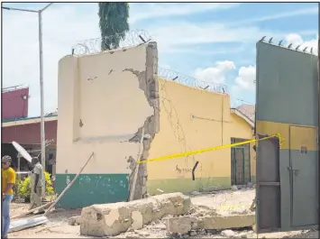  ?? Chinedu Asadu The Associated Press ?? Broken walls are seen Wednesday at the Kuje maximum prison in Abuja after a rebel attack. An estimated 900 inmates escaped in a jailbreak in Nigeria’s capital city.