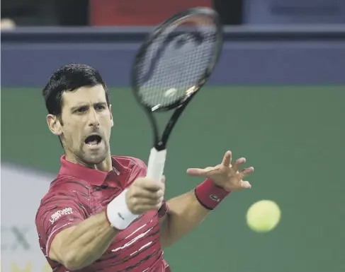  ??  ?? 0 Serbia’s Novak Djokovic plays a forehand during his comfortabl­e 6-3, 6-3 win over Denis Shapovalov at the Shanghai Masters.