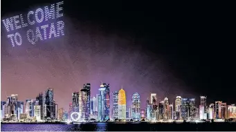  ?? REUTERS ?? A DRONE show with welcoming words is seen above the Doha skyline, before the football World Cup 2022 in Qatar which started yesterday. |