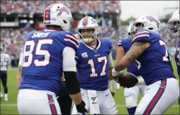  ?? JAMES KENNEY ?? Buffalo Bills quarterbac­k Josh Allen (17) celebrates with tight end Lee Smith (85) after they teamed up for an 8-yard touchdown pass against the Tennessee Titans in the first half of an NFL football game Sunday,