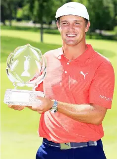  ?? — AFP photo ?? DeChambeau poses with the trophy after winning The Memorial Tournament Presented By Nationwide at Muirfield Village Golf Club in Dublin, Ohio.