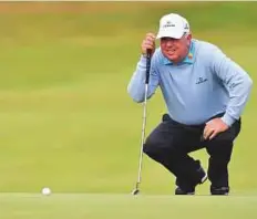  ?? AFP ?? US golfer Mark O’Meara lines up a putt on the 8th green during his opening round on the first day of the Open.