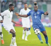  ??  ?? Italy forward Mario Balotelli, right, and Saudi Arabia defender Osama Hawsawi vie for the ball.