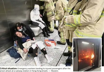  ?? — Reuters ?? Critical situation: Emergency workers tending to injured passengers after the arson attack at a subway station in Hong Kong (inset).