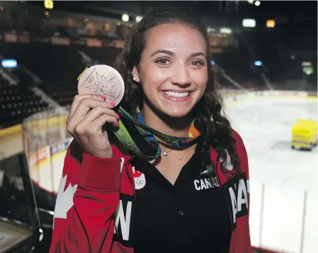  ?? DAN JANISSE ?? Local swimming star Kylie Masse shows off her Olympic bronze medal Friday at the WFCU Centre, where she will compete in the FINA World Swimming Championsh­ips in December. “The entire world’s best swimmers are going to be here in Windsor,” Masse said.
