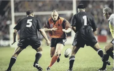  ??  ?? 0 Gregor Townsend kicks past All Blacks Robin Brooke and Carl Hoeft during the 1999 World Cup quarter- final at Murrayfiel­d. The former stand- off now hopes to engineer a famous win at the stadium.