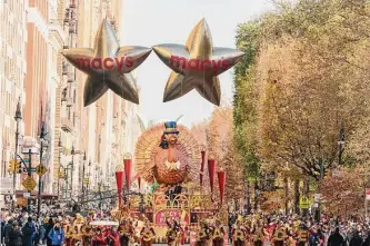  ?? Jeenah Moon/associated Press ?? Tom Turkey, one of 16 massive balloons, leads the way Thursday morning down Central Park West during the Macy’s Thanksgivi­ng Day Parade in New York.