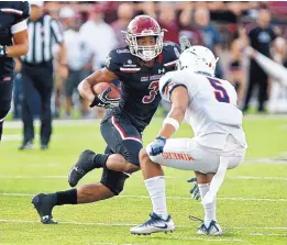  ?? ANDRES LEIGHTON/FOR THE JOURNAL ?? New Mexico State running back Larry Rose III (3) puts a move on UTEP’s Nik Needham before scoring a touchdown during Saturday’s game.