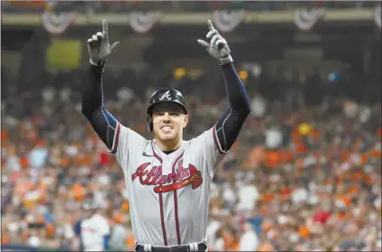  ?? ERIC GAY / AP ?? The Braves’ Freddie Freeman celebrates his home run during the seventh inning in Game 6 of Tuesday’s World Series against the Astros in Houston.