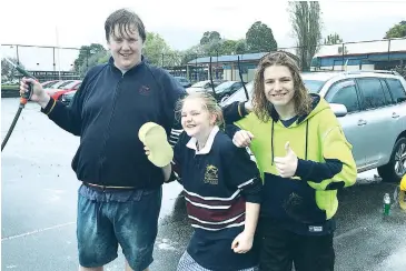  ??  ?? Drouin Secondary College VCAL students Samuel Williams, Britt Carter and James RungeHill take to washing staff cars to raise money for the Cancer Council.