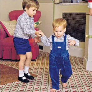  ?? ?? 1985
Prince William gives his younger brother a helping hand as he learns to walk in Kensington Palace