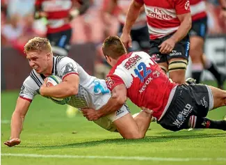  ?? PHOTO: PHOTOSPORT ?? Jack Goodhue scores for the Crusaders in their Super Rugby win against the Lions in Johannesbu­rg.