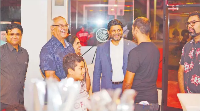  ?? Picture: JOVESA NAISUA ?? Attorney-General Aiyaz Sayed-Khaiyum speaks to the owners of the Grills Restaurant and Bar during the official opening of the restaurant in Suva on Wednesday.