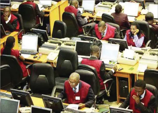  ??  ?? Dealers trading on the floor of the Nigeria Stock Exchange