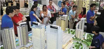  ?? ?? A crowd-puller: A file picture showing people checking out the scale model of The Light City project. The shopping-centre component of the mixed developmen­t will feature a variety of retail tenants rather than a single department­al store, according to Tan.