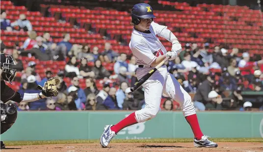  ?? Herald PHotoS by JoSePH PrezioSo ?? MAKING FENWAY MEMORIES: Xaverian’s Kyle Sylvester (above) prepares to connect with the ball during the Hawks’ 3-2 win against St. John’s Prep in the seventh annual ALS Awareness Game yesterday at Fenway Park. Below, the Prep’s Richie Williams collides...