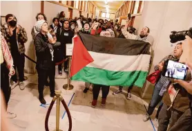  ?? Lea Suzuki/The Chronicle ?? Members of the Arab Resource and Organizati­on Center react on Jan. 9 after the San Francisco Board of Supervisor­s voted 8-3 for a cease-fire resolution.