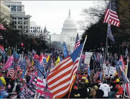  ?? PHOTOS BY LUIS M. ALVAREZ — THE ASSOCIATED PRESS ?? With the U.S. Capitol building in the background, supporters of President Donald Trump stand on Pennsylvan­ia Avenue during a rally at Freedom Plaza on Saturday.