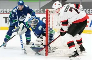 ?? The Associated Press ?? Vancouver Canucks defenceman Tyler Myers watches as Ottawa Senators’ Brady Tkachuk fails to get a shot past Vancouver Canucks goaltender Thatcher Demko in Vancouver on Monday.