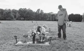  ?? ETHAN HYMAN ehyman@newsobserv­er.com ?? Van Barbour his daughters, Maddie, and younger Oakleigh, visit the grave of his wife and their mother Rachel at Greenlawn Memorial Gardens in Fuquay-Varina in May 2023.