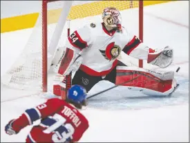  ?? CP PHOTO RYAN REMIORZ ?? Ottawa Senators goaltender Joey Daccord (34) makes the save on Montreal Canadiens right wing Tyler Toffoli (73) during first period NHL hockey action Tuesday in Montreal.
