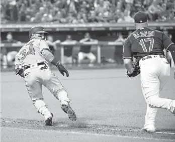  ?? AP Photo/Phil Long ?? ■ Baltimore Orioles' Jonathan Villar runs back towards home plate as Cleveland Indians' Yonder Alonso chases him during the eighth inning a baseball game Friday in Cleveland.