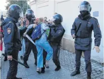  ?? MAXIM SHEMETOV REUTERS ?? Law enforcemen­t officers detain Muscovite Daria Sosnovskay­a after a rally to demand authoritie­s allow opposition candidates to run in the upcoming local election in Moscow, Russia on Aug. 10. •