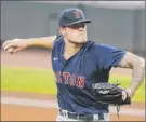  ?? Todd Kirkland / Getty Images ?? Tanner Houck of the Red Sox delivers a pitch in the first inning against the Braves on Saturday. Houck finished with 10 strikeouts.