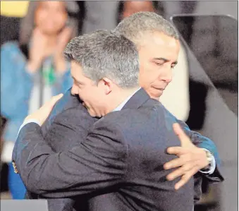  ?? Hearst Connecticu­t Media file photo ?? President Barack Obama hugs Ian Hockley, father of Dylan, before Obama was to speak in West Hartford on gun control.