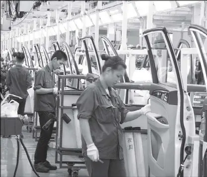  ?? REUTERS ?? Employees work at a production line inside a factory of Saic GM Wuling in Liuzhou, Guangxi Zhuang Autonomous Region, China.