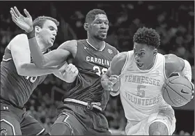  ?? AP/WADE PAYNE ?? (right) drives to the basket as he’s defended by South Carolina forwards Chris Silva (middle) and Felipe Haase during the second half of the top-ranked Volunteers’ 85-73 victory over the Gamecocks on Wednesday in Knoxville, Tenn. Schofield scored 21 points and grabbed 10 rebounds to lead the Volunteers.