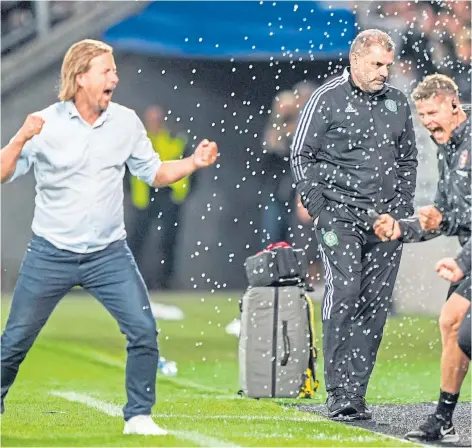  ?? ?? Celtic manager Ange Postecoglo­u (centre) looks dejected as FC Midtjyllan­d manager Bo Henriksen celebrates at full-time in the Uefa Champions League second qualifying round match in Herning, Denmark in July last year.