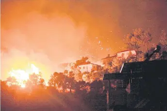  ?? — AFP photos ?? Photo shows flames rising from a fire spreading in the Aegean coast city of Oren near Milas as Turkey struggles against its deadliest wildfires in decades.