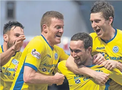  ?? Picture: SNS. ?? Chris Kane, third left, is mobbed by team-mates after grabbing Saints’ late winner.