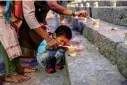  ?? (AP Photo/Rafiq Maqbool, File) ?? A Hindu boy lights an oil lamp at the Banganga pond as they celebrate Dev Diwali festival in Mumbai, India, Nov. 7, 2022. Diwali is the most important festival of the year in India and for Hindus in particular. It is celebrated across faiths by more than a billion people in the world’s most populous nation and the diaspora. This year, Diwali begins Friday, Nov. 10, 2023, and the festival will be observed on Sunday, Nov. 12.