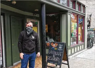  ?? BONNIE MEIBERS / STAFF ?? Andy Rowe, the assistant general manager at Blind Bob’s in the Oregon District, stands outside the popular restaurant and bar. The Downtown Dayton Gift Card Bonus Buy program is to get people to try out new businesses they may have never visited or patronized before.