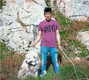  ??  ?? (Below) Greenlandi­c musher Michael Kunak, 25, with his dog Dorner in Kulusuk.