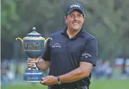  ?? EDUARDO VERDUGO/THE ASSOCIATED PRESS ?? Phil Mickelson poses with his Mexico Championsh­ip trophy Sunday at the Chapultepe­c Golf Club in Mexico City.