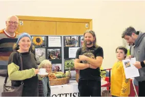  ??  ?? Green fingers This lot take a look at the Scottish Smallholde­rs Associatio­n stall