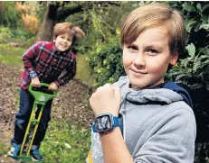  ??  ?? Watch out: Conrad, 12, and Caspar, nine, test their Vtech Smartwatch­es