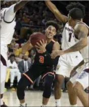  ?? RALPH FRESO — THE ASSOCIATED PRESS ?? Princeton guard Devin Cannady (3) drives to the basket as Arizona State’s Zylan Cheatham, left, Remy Martin (1) and Rob Edwards defend during the first half of Saturday’s game in Tempe, Ariz.