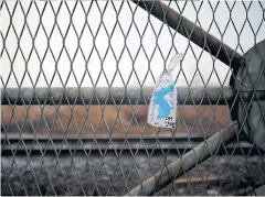  ??  ?? BELOW A unificatio­n flag hangs on a military fence near the Demilitari­sed Zone separating the two Koreas in Paju, South Korea last month. The Korean characters read: “I want to walk freely beyond this military fence.”