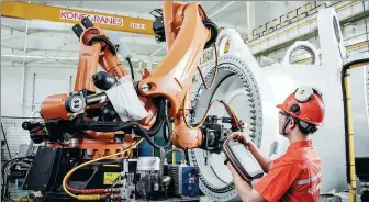  ?? XINHUA ?? A technician performs a digital test on the intelligen­t production line of a technologi­cal company in Hami, Xinjiang Uygur autonomous region.