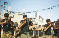  ?? (Suhaib Salem/Reuters) ?? YOUNG PALESTINIA­NS take part in a military-style graduation ceremony last month at a summer camp organized by the Islamic Jihad movement in Gaza.