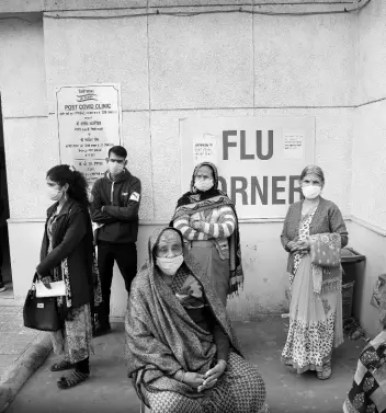  ?? AP ?? People wait outside a health centre to get tested for COVID-19 in New Delhi, India, on February 11.